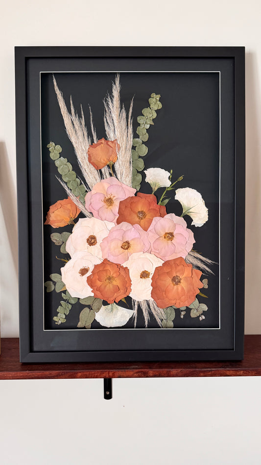 Flower preservation on black mat background wiht black frame