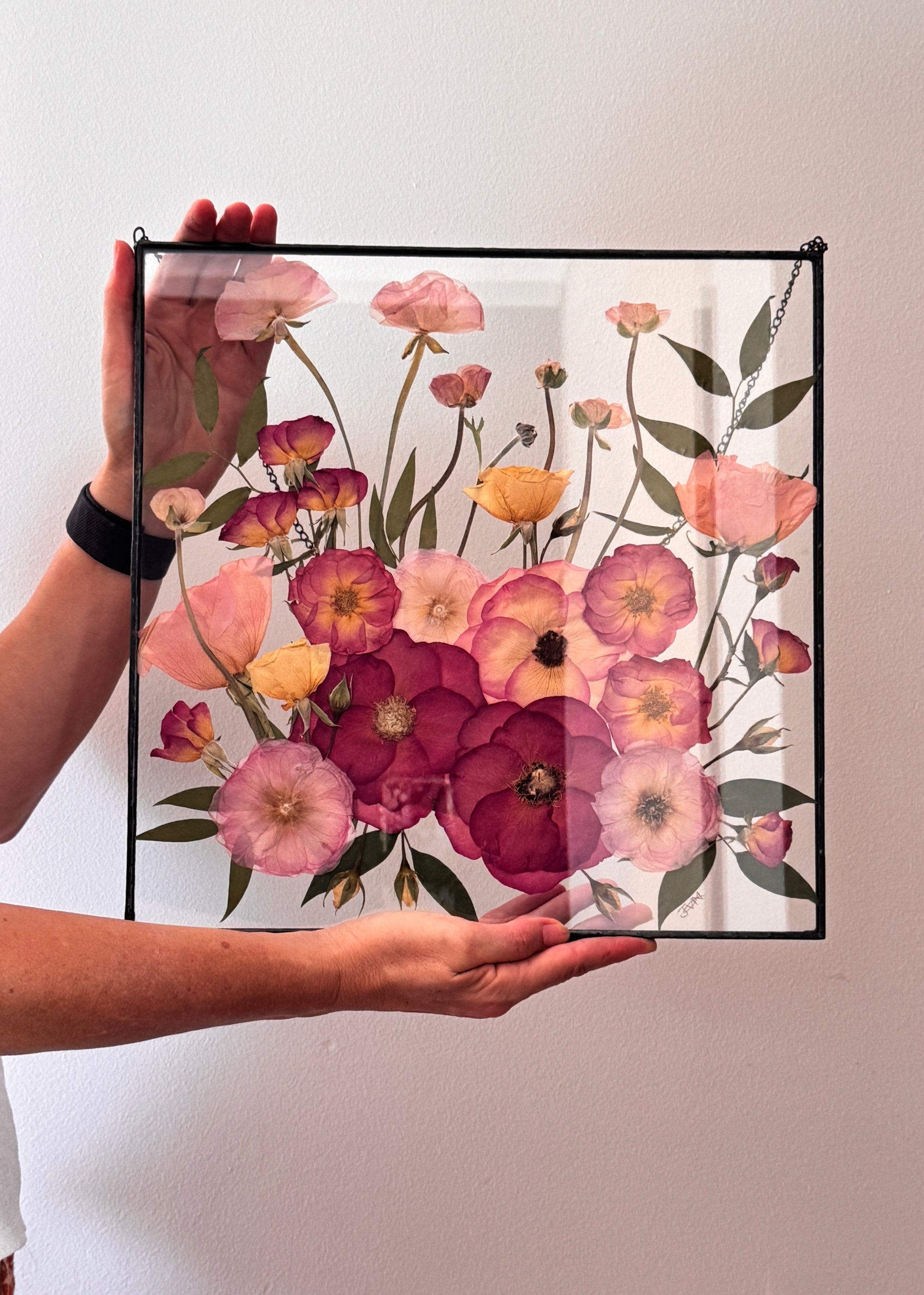 Pink wedding bouquet framed in square metal frame