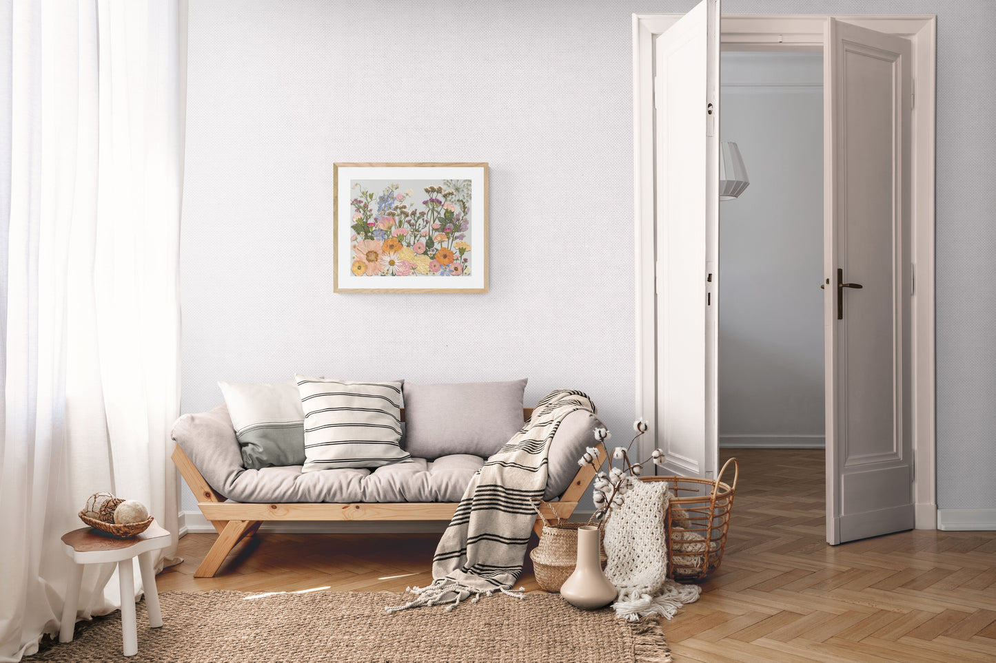 Living room with a wooden sofa, cushions, and a bright coloured pressed flower art on the wall.