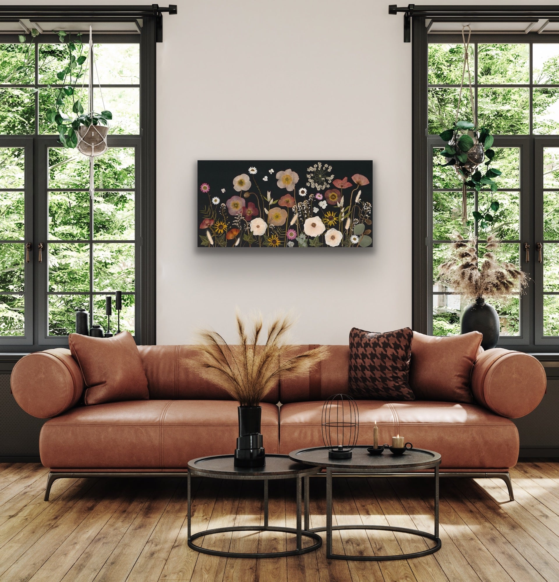 Pressed poppy flowere art displayed in a modern living room with a brown leather sofa and round coffee tables.