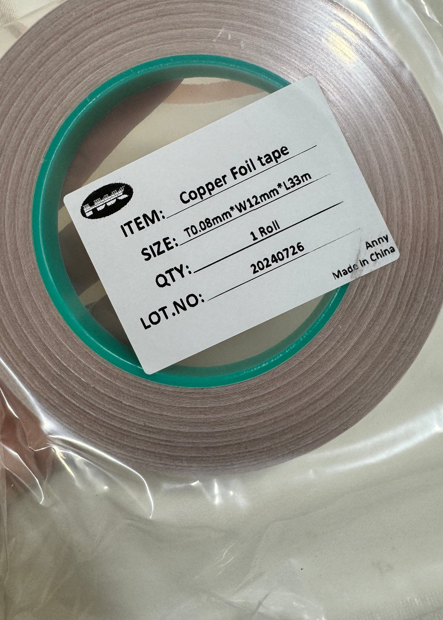 Roll of copper foil tape with a label on a white background