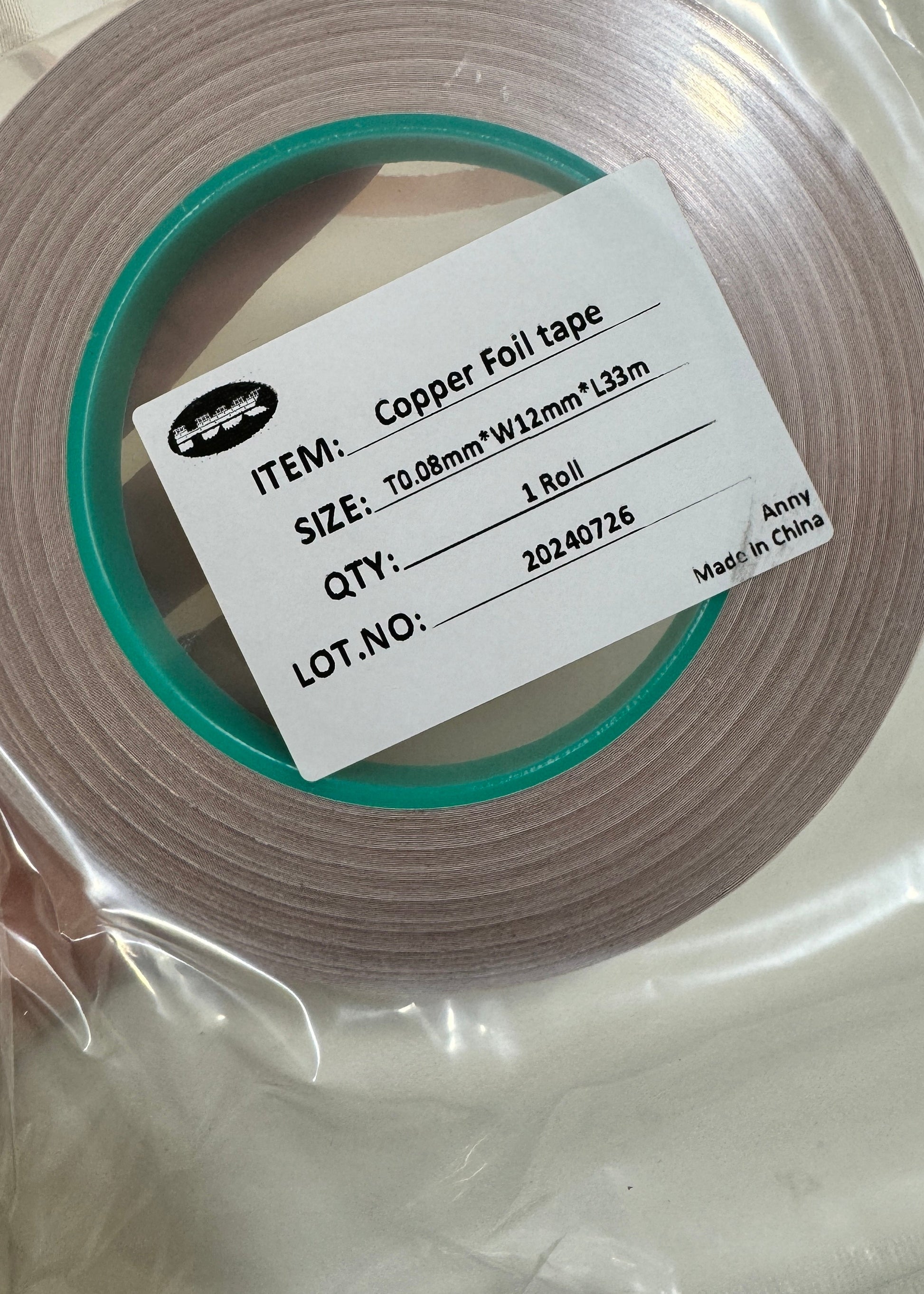 Roll of copper foil tape with a label on a white background