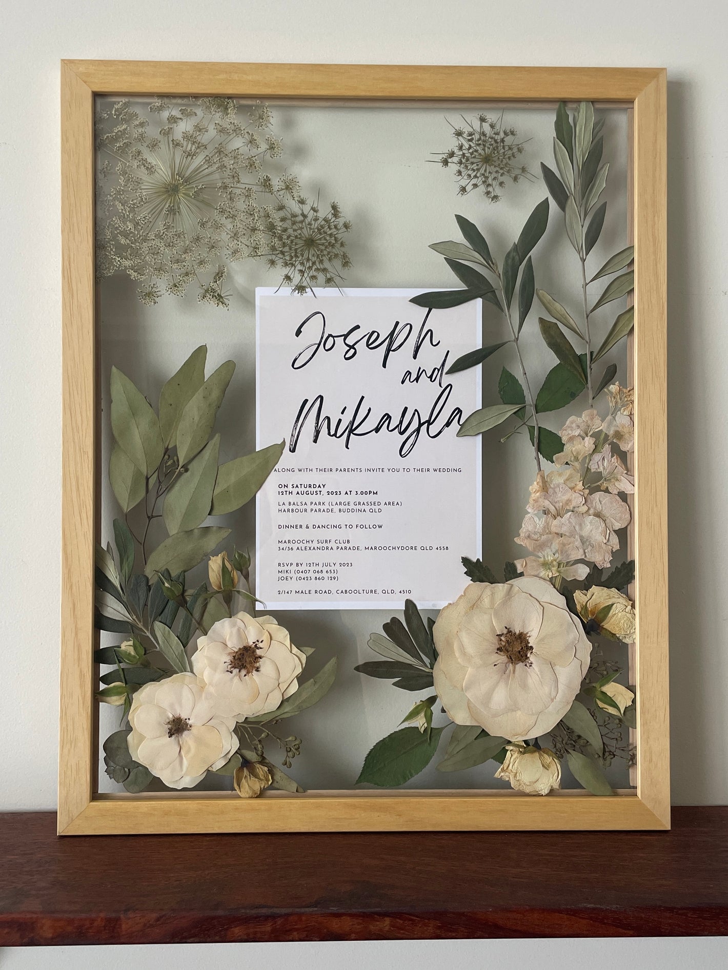 Pressed wedding bouquet including wedding invitation