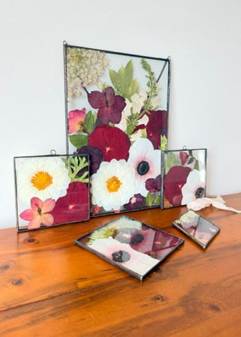 Collection of soldered black red and white framed pressed flowers